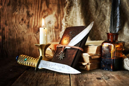 diary and feather with a bottle of rumの写真素材