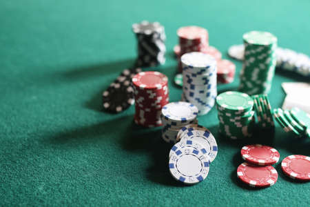 set of chips and cards on a green baize gambling casinoの写真素材