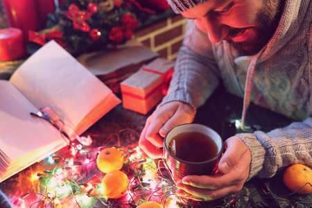 man with a blank book in his hands for the New Years table withの写真素材