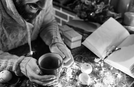 monochrome photo of man with a blank book in his hands for the Nの写真素材