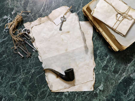 retro papers and book on detective work table with tools backgroundの写真素材