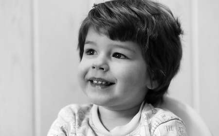 black and white photo of  kid smiling and have fun white backgroの写真素材