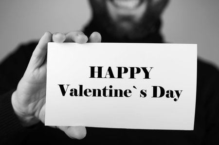 happy valentine s day a small white piece of paper in his hand man