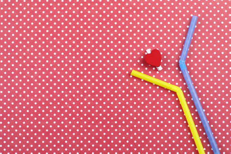 colorful cocktail tubes lie on a bright color backgroundの写真素材