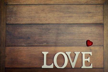 word Love from wooden letters on a wood backgroundの写真素材