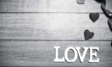 the word love made up of white wooden letters on a wooden backgroundの写真素材