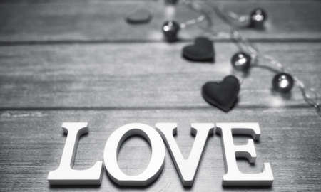 the word love made up of white wooden letters on a wooden backgroundの写真素材