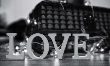 the word love made up of white wooden letters on a wooden backgroundの写真素材