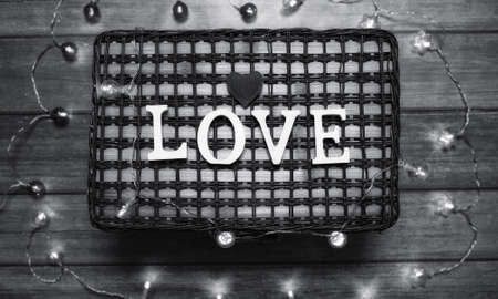 the word love made up of white wooden letters on a wooden backgroundの写真素材