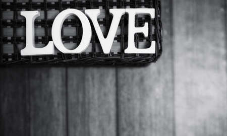the word love made up of white wooden letters on a wooden backgroundの写真素材