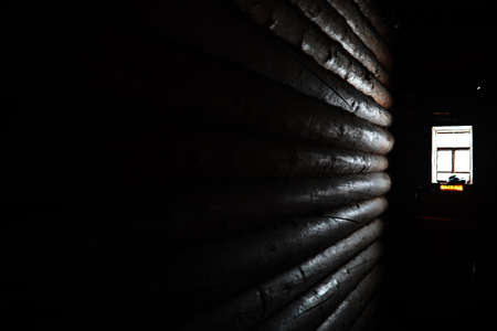 sunlight coming through the wooden window in old dark roomの写真素材