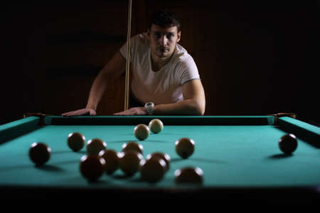 hansome man playing billiards aloneの写真素材