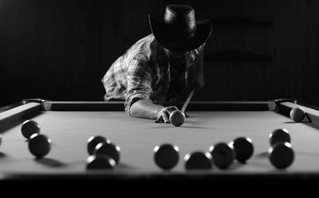 monochrome photo young man playing billiardsの写真素材