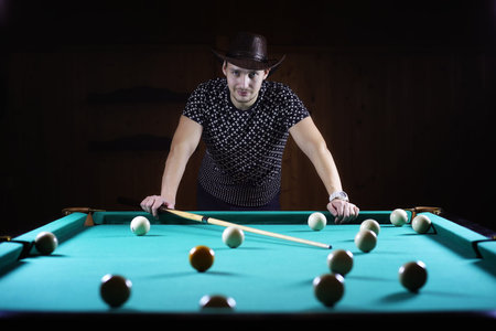 hansome man playing billiards aloneの写真素材