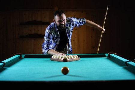 hansome man playing billiards aloneの写真素材