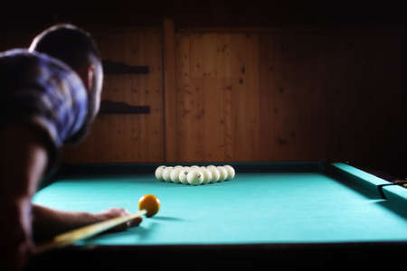 hansome man playing billiards aloneの写真素材