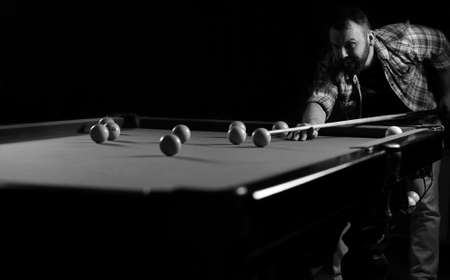 monochrome photo young man playing billiardsの写真素材