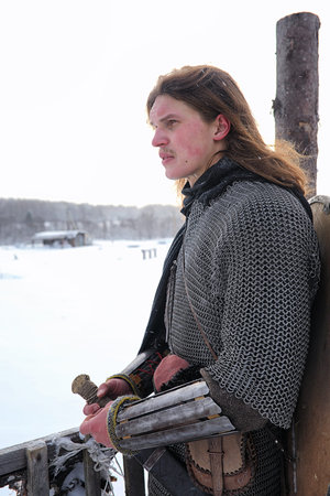 Defender the young warrior in mail armor armed with a sword