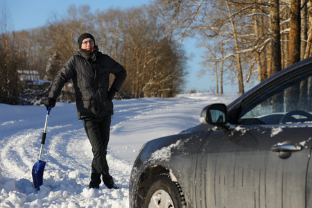 man remove snow with shovel from the road in winterの写真素材