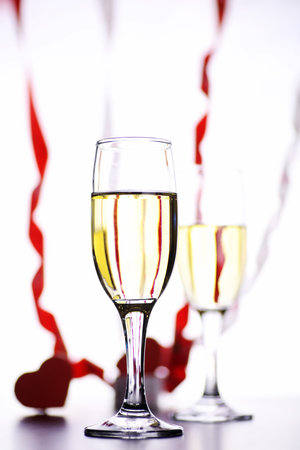 glass of white wine on a table on a white background isolateの写真素材