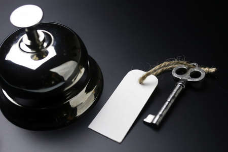 bell and the key at the reception in the hotelの写真素材