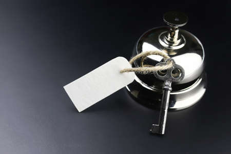bell and the key at the reception in the hotelの写真素材