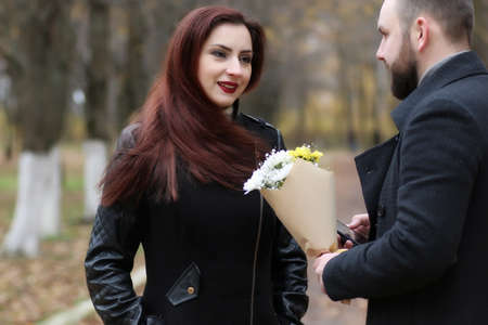 couple in love date in autumn park sunny dayの写真素材