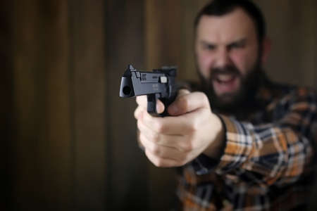 man with put on protective goggles and ear training in pistol shの写真素材