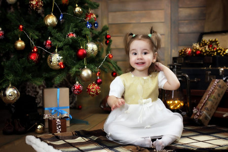 night before Christmas little baby sitting on the floor and play
