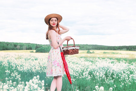 girl in a summer meadow with white flowerの写真素材