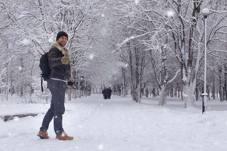bearded man walking in a winter parkの写真素材
