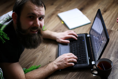 the man on the floor computerの写真素材