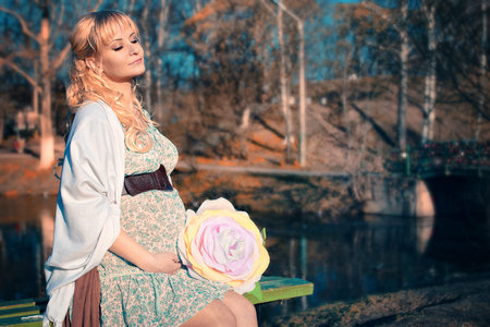 pregnant woman on the walk city park in autumn dayの写真素材
