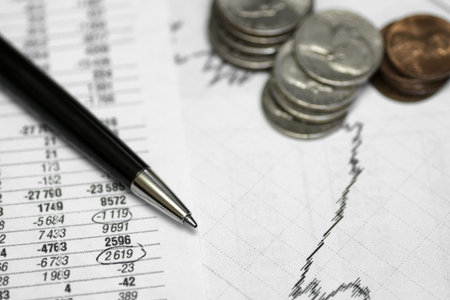 pen on paper with the price quotes and charts