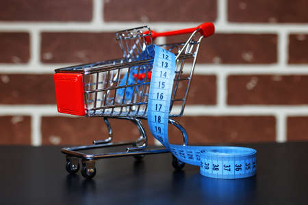 Trolley for dietary products for sale brick wall backgroundの写真素材