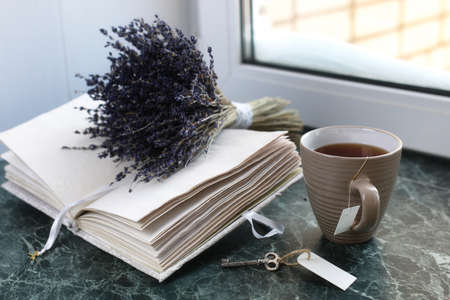 Vintage notebook on green marble windowsill opened with blank paの写真素材