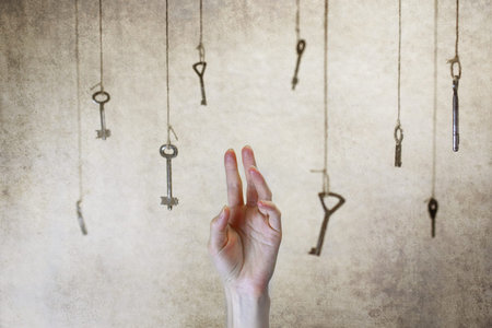 hand stretching for one of the many old vintage keys hanging on threads