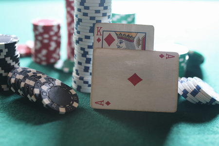 set of chips and cards on a green baize gambling casino
