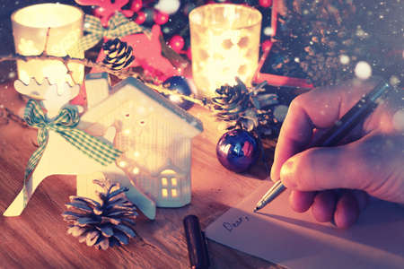 new year hand write on table with pine cone candleの写真素材