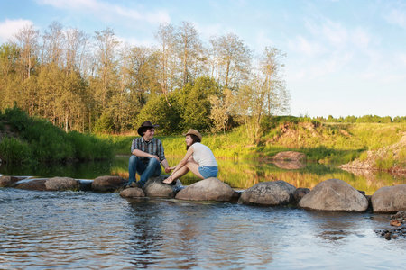 couple of young people admire the sunset in the spring evening
