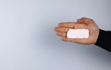 small white piece of paper in his hand manの写真素材