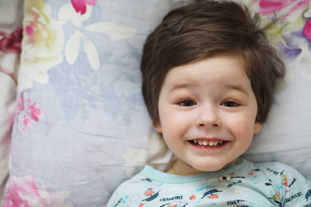 Portrait of a young child lying on a pillow