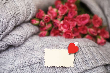 Bouquet of red roses on textile sweaterの写真素材