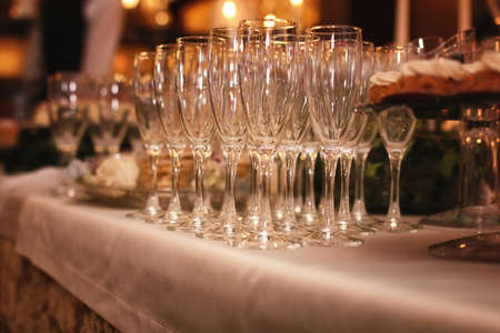 Glass wine glasses on the table served in the restaurantの写真素材