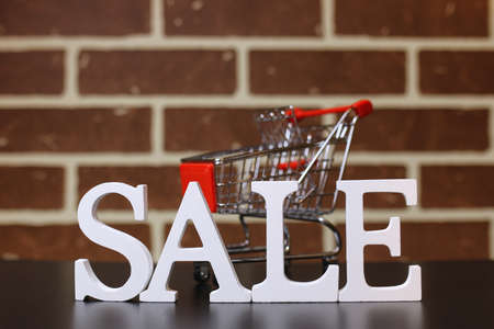 Trolley for products on a brick wall background New Years saleの写真素材