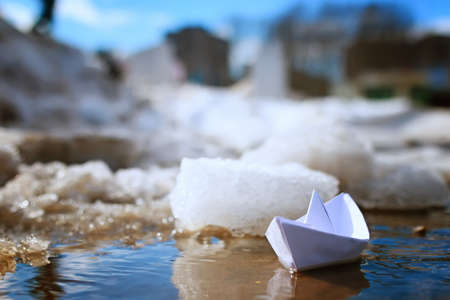 tinted photo paper boat on spring streetの写真素材