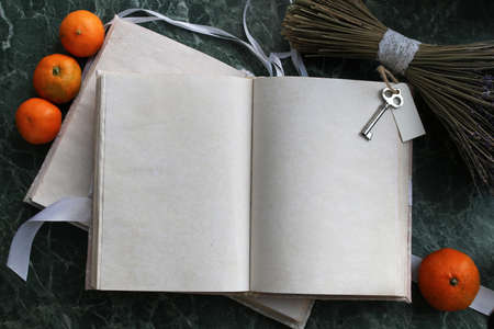 pages opened vintage book on green marble countertopの写真素材