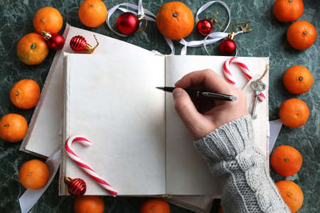 pages opened vintage book on green marble countertopの写真素材