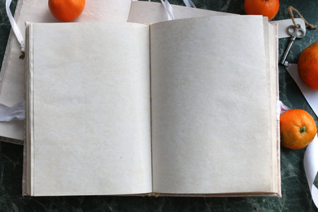 pages opened vintage book on green marble countertopの写真素材