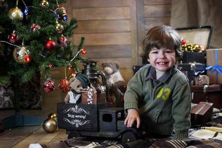 small child playing with toys with christmas decorationsの写真素材